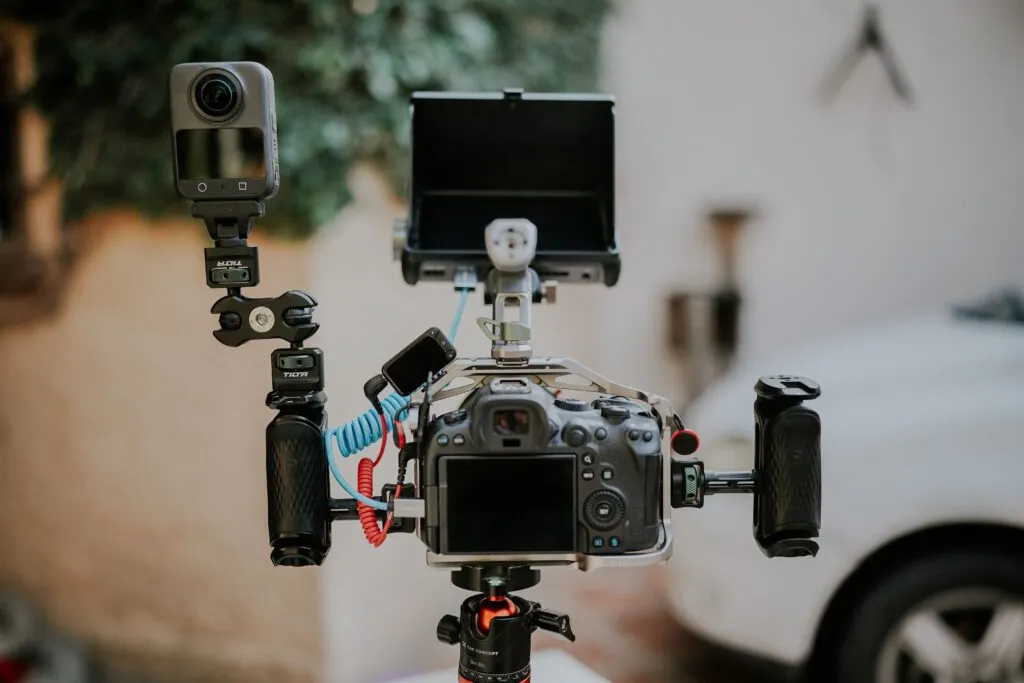 Close-up image of advanced video and photography equipment with multiple accessories in an indoor setting.